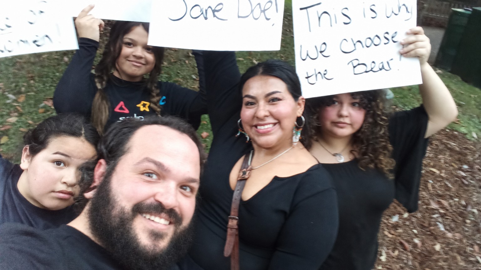 Josh and Angela Dyer with family members at the October 4, 2026 University of Oregon march, holding signs about consent and safety.